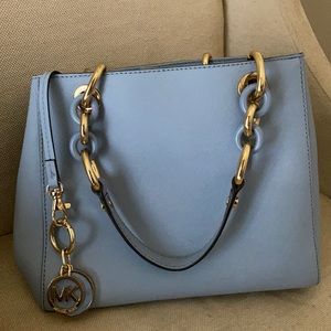 This is a blue Michael Kors hand bag